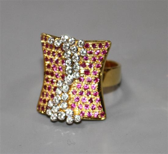 A modern yellow metal (etched? 18k), pave set ruby and diamond dress ring, size N, gross 10 grams.